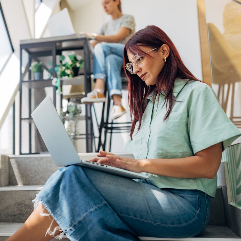Happy female using laptop