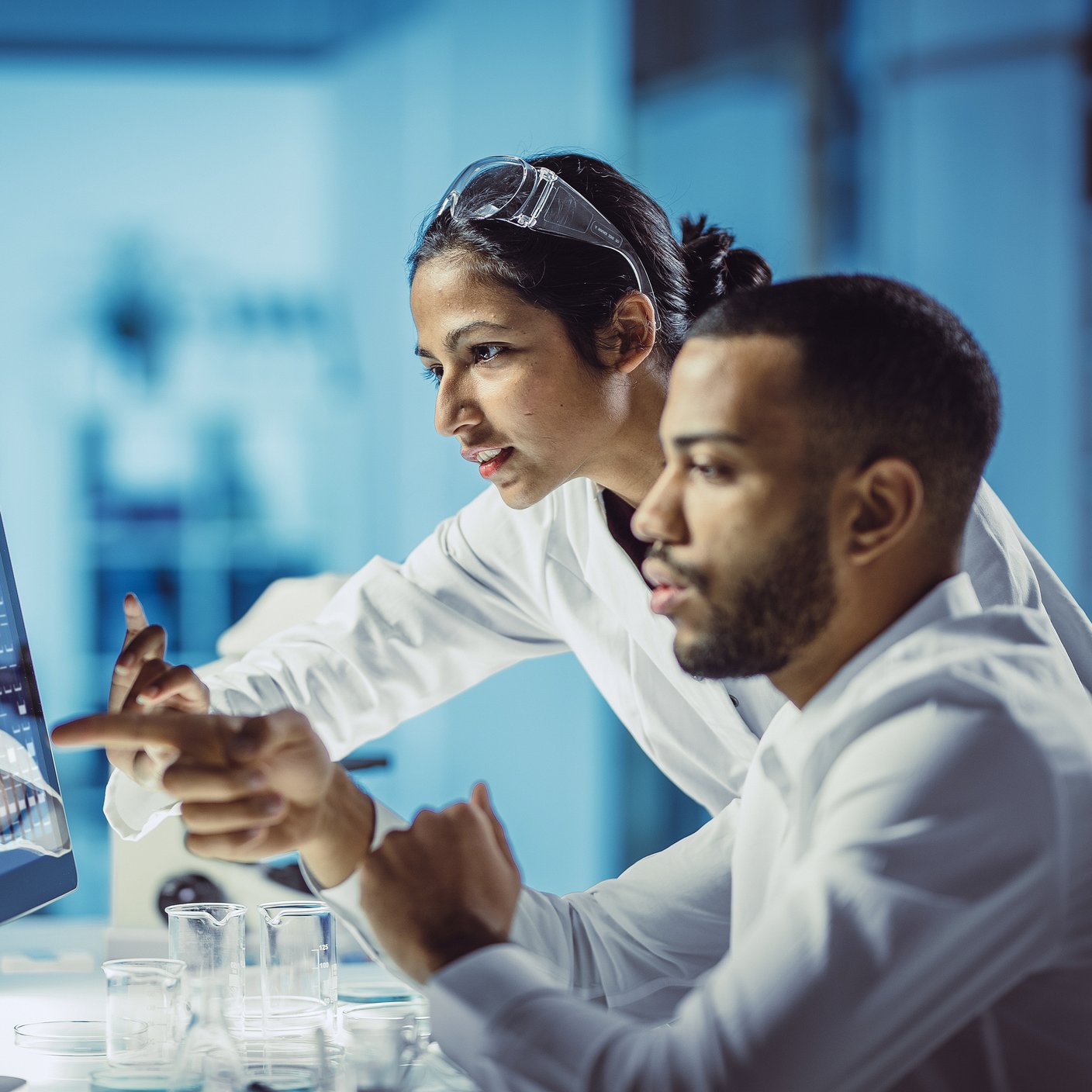 Scientists working in the laboratory, using touch screen