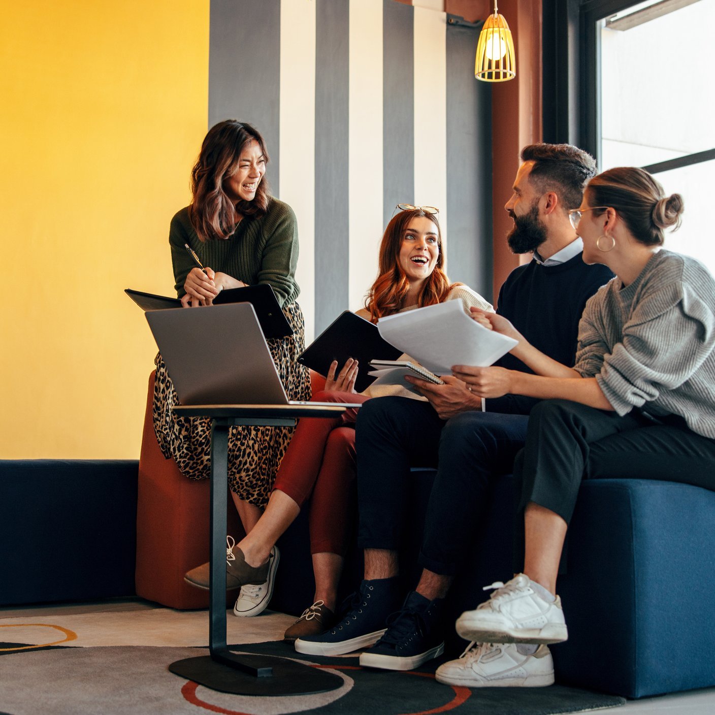 Multicultural businesspeople working in an office lobby.