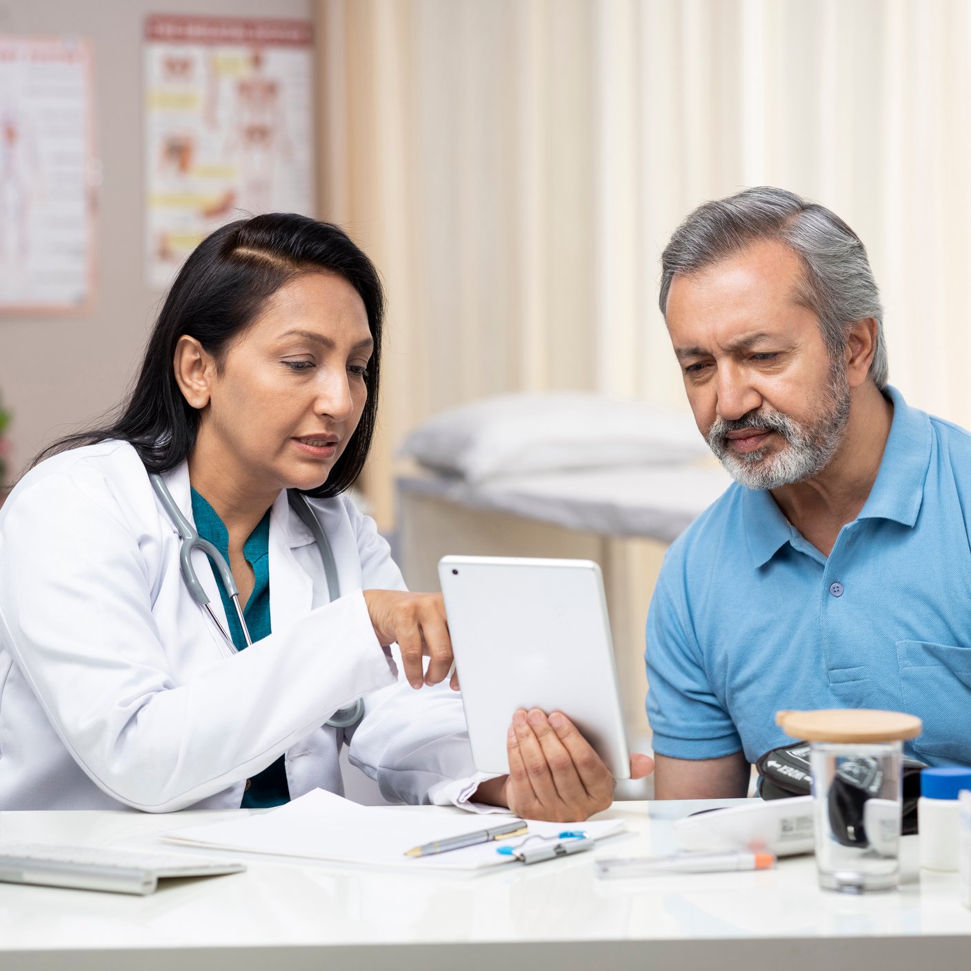 India, Doctor, Indian Ethnicity, Digital Tablet, Patient, using digital tablet, finger, pointing.