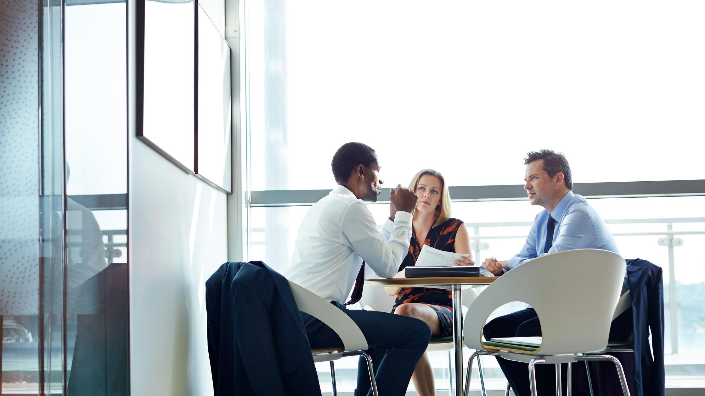 Female professionals planning strategy in a meeting at creative office.